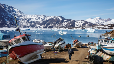 A man walks to his boat past a number of abandoned and dry-docked boats in the town of Tasiilaq, Greenland, June 15, 2018. © REUTERS/Lucas Jackson