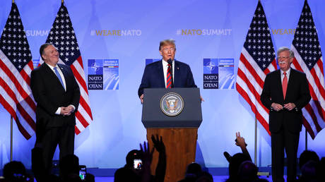 President Trump speaks at a NATO summit in Brussels, alongside Mike Pompeo and John Bolton © Reuters / Yves Herman