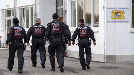 FILE PHOTO: Police officers walk on the premises of the Stephansposching refugee shelter, Germany, October 24, 2018.