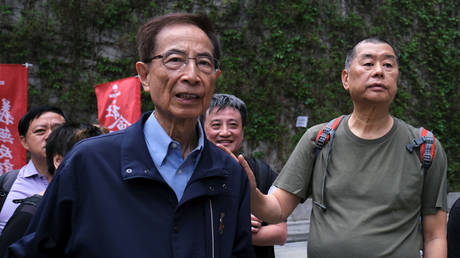 FILE PHOTO: Hong Kong politician Martin Lee and Founder of Next Media Jimmy Lai march during a protest to demand authorities scrap a proposed extradition bill with China, in Hong Kong, China, on March 31, 2019.
