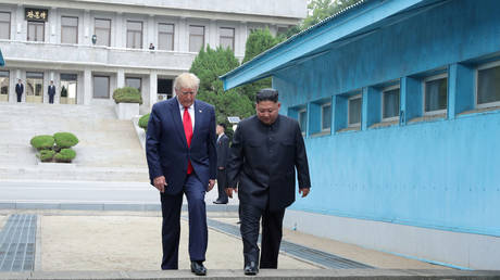 FILE PHOTO: Donald Trump and Kim Jong Un cross over a demarcation line at the demilitarized zone (DMZ) on June 30, 2019 © KCNA via REUTERS