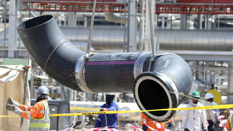 Workers fix a pipeline at the damaged site of Saudi Aramco oil facility in Khurais, Saudi Arabia, September 20, 2019.