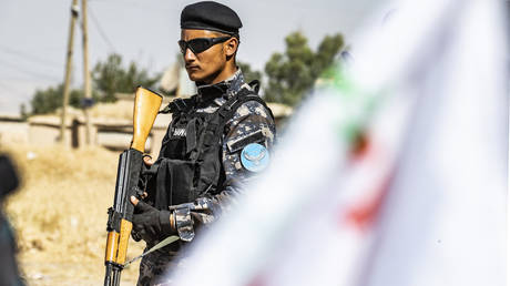 A member of the Kurdish Internal Security Police Force of Asayesh stands guard during a demonstration by Syrian Kurds against Turkish threats to launch a military operation on their region, in the town of Al-Qahtaniyah, in northeastern Syrian Al-Hasakah Governorate on October 7, 2019.