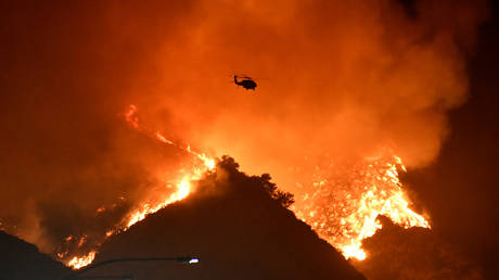 A helicopter flies over the Getty Fire west of Los Angeles, California, October 28, 2019.