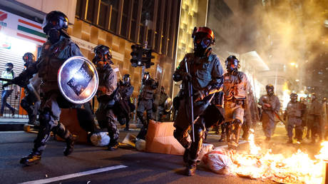 FILE PHOTO: Hong Kong police pass a burning barricade, November 2, 2019