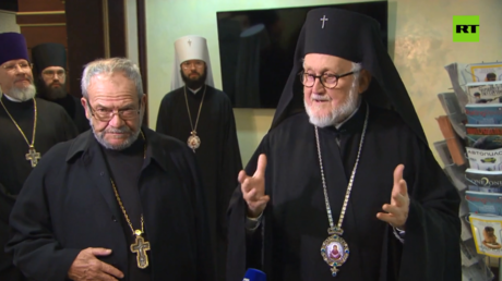Archbishop John (R) meets reporters in Moscow.
