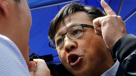 FILE PHOTO: Pro-Beijing lawmaker Junius Ho argues with an opposition lawmaker in Hong Kong, China.