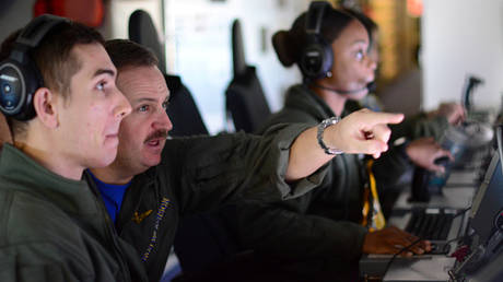 FILE PHOTO: Members of the US Navy aboard the Boeing P-8A Poseidon plane