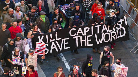 FILE PHOTO: Members of the Occupy Wall Street movement march down Broadway during a May Day demonstration in New York, May 1, 2012