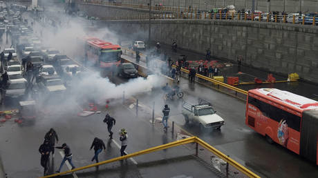 FILE PHOTO: Riot police tries to disperse people as they protest on a highway against increased gasoline price in Tehran, Iran, on November 16, 2019.