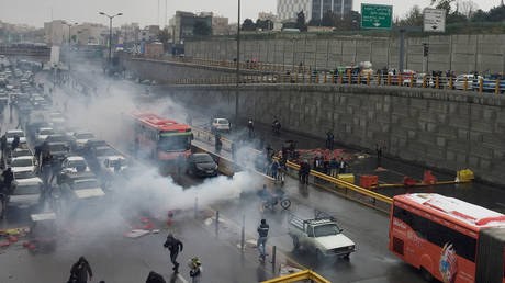Riot police tries to disperse people as they protest on a highway against increased gas price in Tehran, Iran 
November 16, 2019