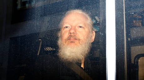 FILE PHOTO WikiLeaks founder Julian Assange is seen in a police van, after he was arrested by British police, in London, Britain April 11, 2019. © REUTERS/Henry Nicholls