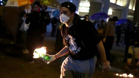 An anti-government demonstrator carries a Molotov cocktail during clashes in Hong Kong. © Reuters / Athit Perawongmetha