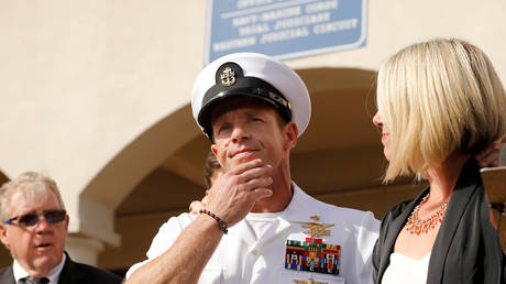 FILE PHOTO: Navy SEAL Edward Gallagher at a press event with his wife after being acquitted on most of the charges he faced during his court-martial.