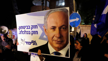 Supporters of Israeli Prime Minister Benjamin Netanyahu protest outside his residence following Israel's Attorney General Avichai Mandelblit's indictment ruling in Jerusalem.
