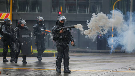 A riot police officer uses a tear gas weapon during a protest in Bogota, Colombia, November 21, 2019.