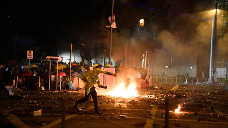 Hong Kong 'pro-democracy' protester throws a petrol bomb at police