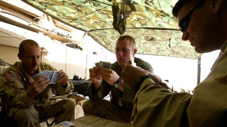 A US army tank combat team plays cards in a makeshift tent in the desert outside Kuwait City
March 13, 2003