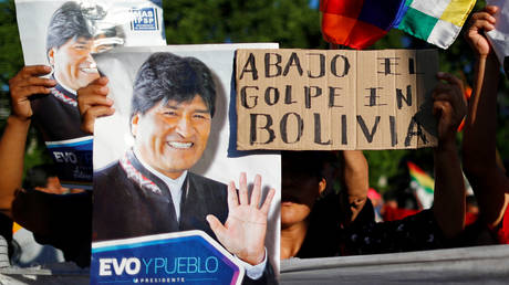 Supporters of ousted President Evo Morales hold a sign that reads "Down with the coup in Bolivia," November 22, 2019.