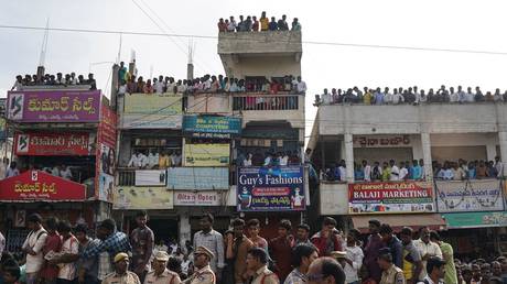 Police officers stand guard as people attend a protest demanding justice over the  rape and murder of a 27-year-old veterinarian Priyanka Reddy in Hyderabad, India, November 30, 2019