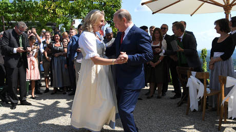 Karin Kneissl and Vladimir Putin at her wedding in Gamlitz, Austria, August 18, 2018. © Pool via Reuters / Roland Schlager