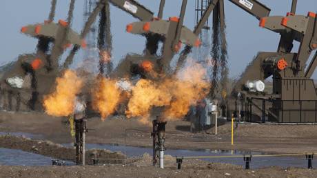 FILE PHOTO: Natural gas is flared off as oil is pumped in the Bakken shale formation in North Dakota