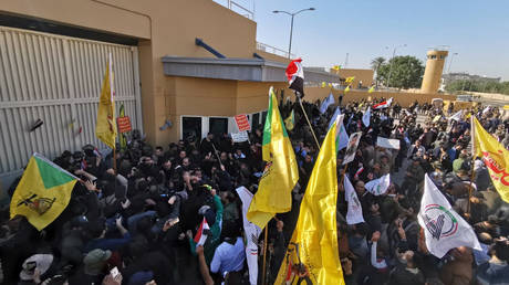 Protesters and militia fighters gather to condemn air strikes on bases belonging to Hashd al-Shaabi (paramilitary forces), outside the main gate of the U.S. Embassy in Baghdad, Iraq December 31, 2019.