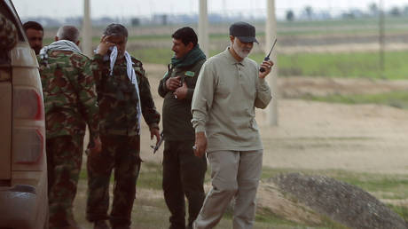 FILE PHOTO: Iranian general, Qassem Soleimani, uses a walkie-talkie at the frontline during  an offensive against Islamic State militants in the town of Tal Ksaiba, Iraq, on March 8, 2015.