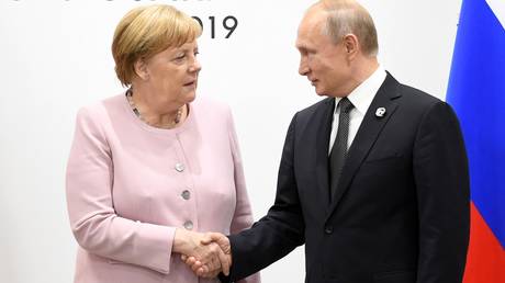 FILE PHOTO Angela Merkel and Vladimir Putin during a G20 meeting in Osakam Japan in June 2019. © Iliya Pitalev / Sputnik