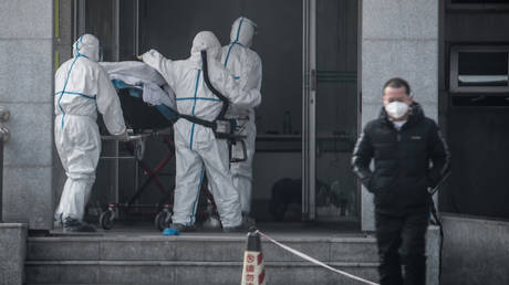 A patient being carried into the Jinyintan hospital in Wuhan, China.