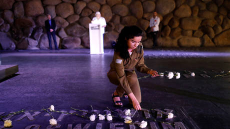 FILE PHOTO: An Israeli soldier lays flowers at the Yad Vashem World Holocaust Remembrance Center, in Jerusalem.