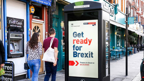 People walk past a ''Get ready for Brexit'' digital advert on the back of a telephone box in north London © Global Look Press / Dinendra Haria