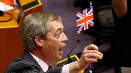 Brexit Party leader Nigel Farage holds a Union Jack flag at the European Parliament in Brussels, Belgium January 29, 2020.