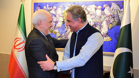 Pakistan's Foreign Minister Shah Mehmood Qureshi greets his Iranian counterpart Mohammad Javad Zarif, May 24, 2019