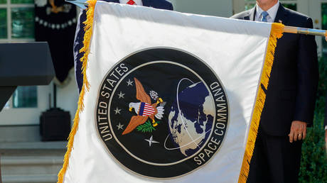 US President Donald Trump stands behind a U.S. Space Command flag with Vice President Mike Pence