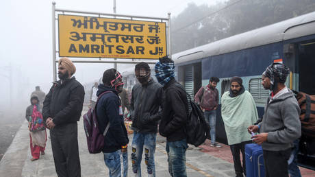 FILE PHOTO Passengers wait for a train amid dense fog during a cold day at a railway station in Amritsar on December 30, 2019. ©  AFP / NARINDER NANU