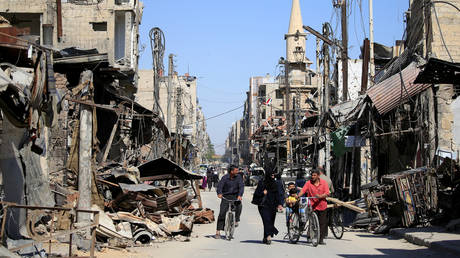 FILE PHOTO: People walk in a street during a media tour in Douma near Damascus, April, 2018