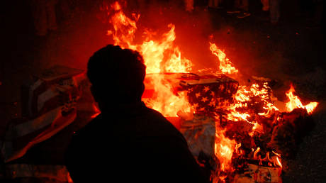 FILE PHOTO: Protesters burn mock coffins draped in flags of the US and Israel during a protest over the assassination of Iranian Major-General Qassem Soleimani.