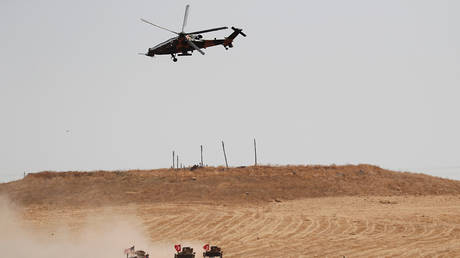 FILE PHOTO: A Turkish military helicopter flies over as Turkish and U.S. troops return from a joint U.S.-Turkey patrol in northern Syria, as it is pictured from near the Turkish town of Akcakale, Turkey, September 8, 2019. © REUTERS/Murad Sezer