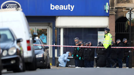 Police officers and forensic officer are seen near the site where a man was shot by armed officers in Streatham, south London, Britain, February 3, 2020.