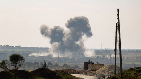 Smoke and dust rise from an explosion in the militant-held town of Sarmin in Syria's Idlib on February 2, 2020.