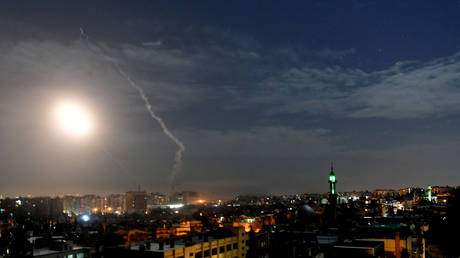 FILE PHOTO: Missile fire is seen over Damascus, Syria.