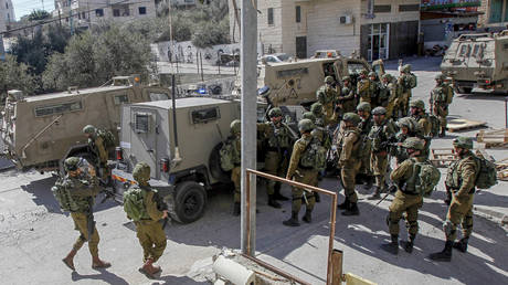Israeli troops are pictured during the manhunt for the car ramming suspect.