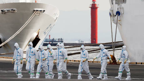 Men wearing protective gear are seen near the cruise ship Diamond Princess, where 64 people have tested positive for coronavirus in Yokohama, Japan, February 7, 2020.