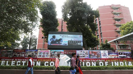 FILE PHOTO: People walk past the Election Commission of India office building in New Delhi, India.