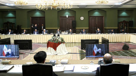 Iranian President Hassan Rouhani is seen on a screen as he is speaking during the cabinet meeting in Tehran, March 4, 2020. © Reuters / Official presidential website