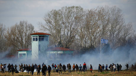 Migrants gather on the Turkish side of the border at Pazarkule crossing in Edirne, trying to break through into Kastanies, Greece, March 7, 2020.