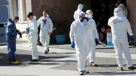 Workers dressed in protective garments prepare to sanitise a buildingin Rome, Italy on March 8, 2020.