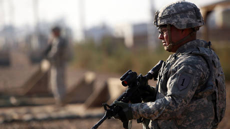 An American soldier stands guard at the Taji base complex