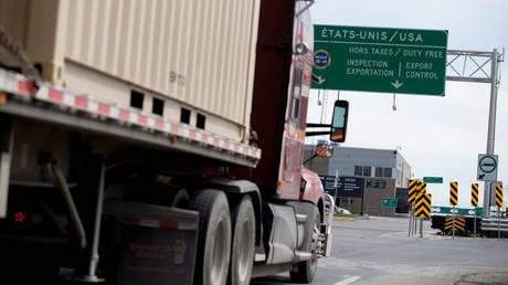 FILE PHOTO: A truck heads towards the United States at the Lacolle border crossing in Lacolle, Quebec, Canada